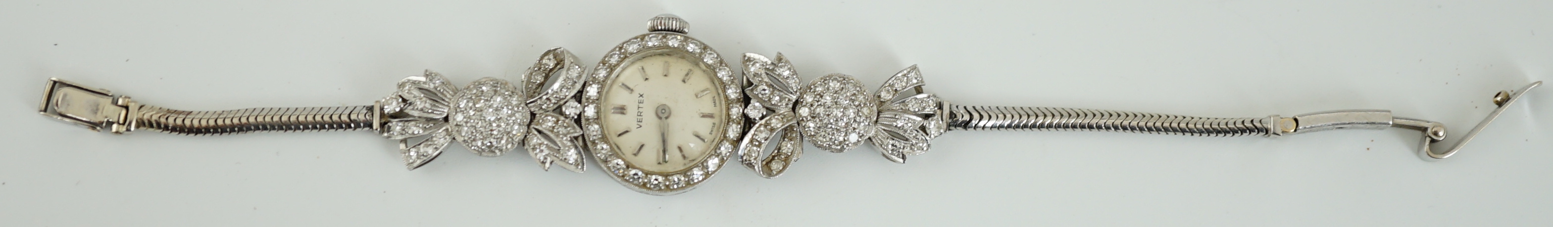 A lady's mid 20th century platinum and round cut diamond set Vertex manual wind cocktail watch